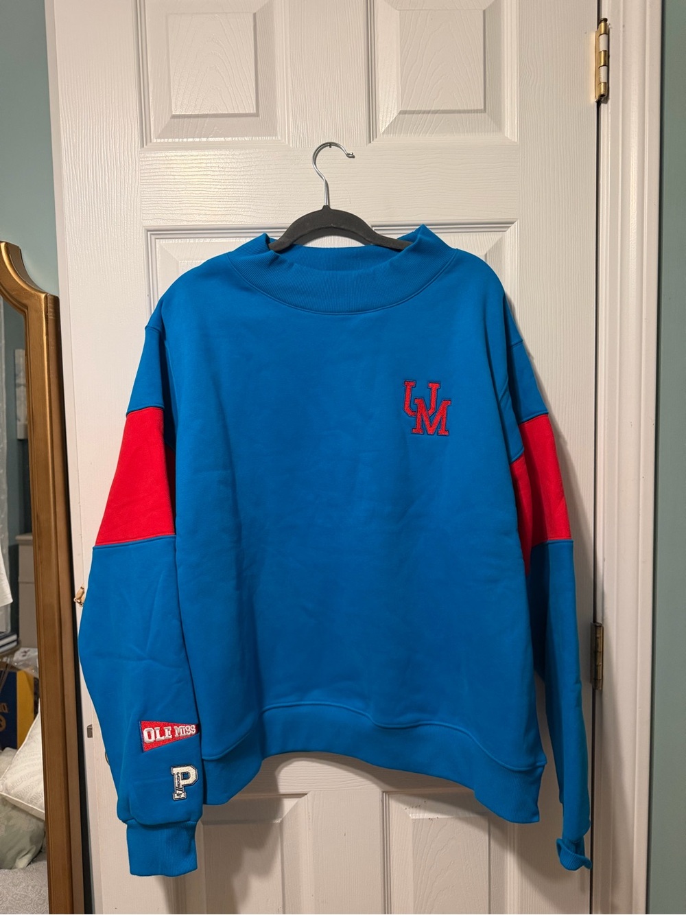 Blue Crewneck Sweatshirt with Red Sleeve Panels and Embroidered Logo